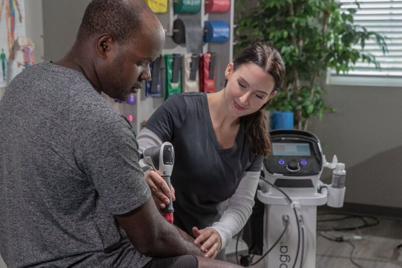 Photo of a Chattanooga-RPW2 being used on a patient's forearm