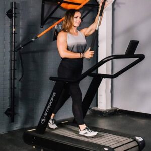 Photo of a woman using a Stroops Optimill Motorless Treadmill