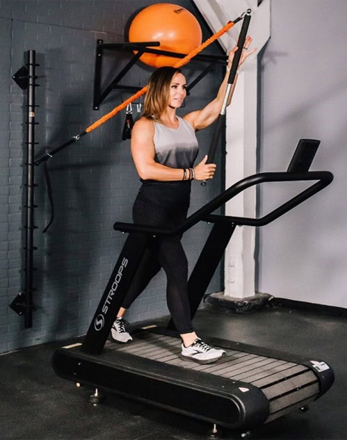 Photo of a woman using a Stroops Optimill Motorless Treadmill