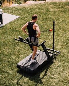 Photo of a man using a Stroops Optimill Motorless Treadmill outside