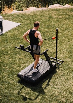 Photo of a man using a Stroops Optimill Motorless Treadmill outside