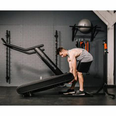 Photo of a man lifting a Stroops Optimill Motorless Treadmill